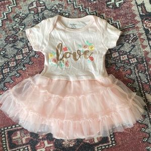 Baby girl pink ruffle one piece set with floral print and love across front.